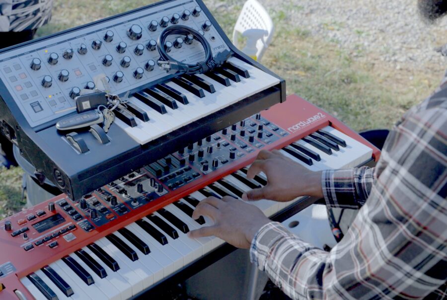 Person playing piano at the 1 year anniversary party for Castle Studios.