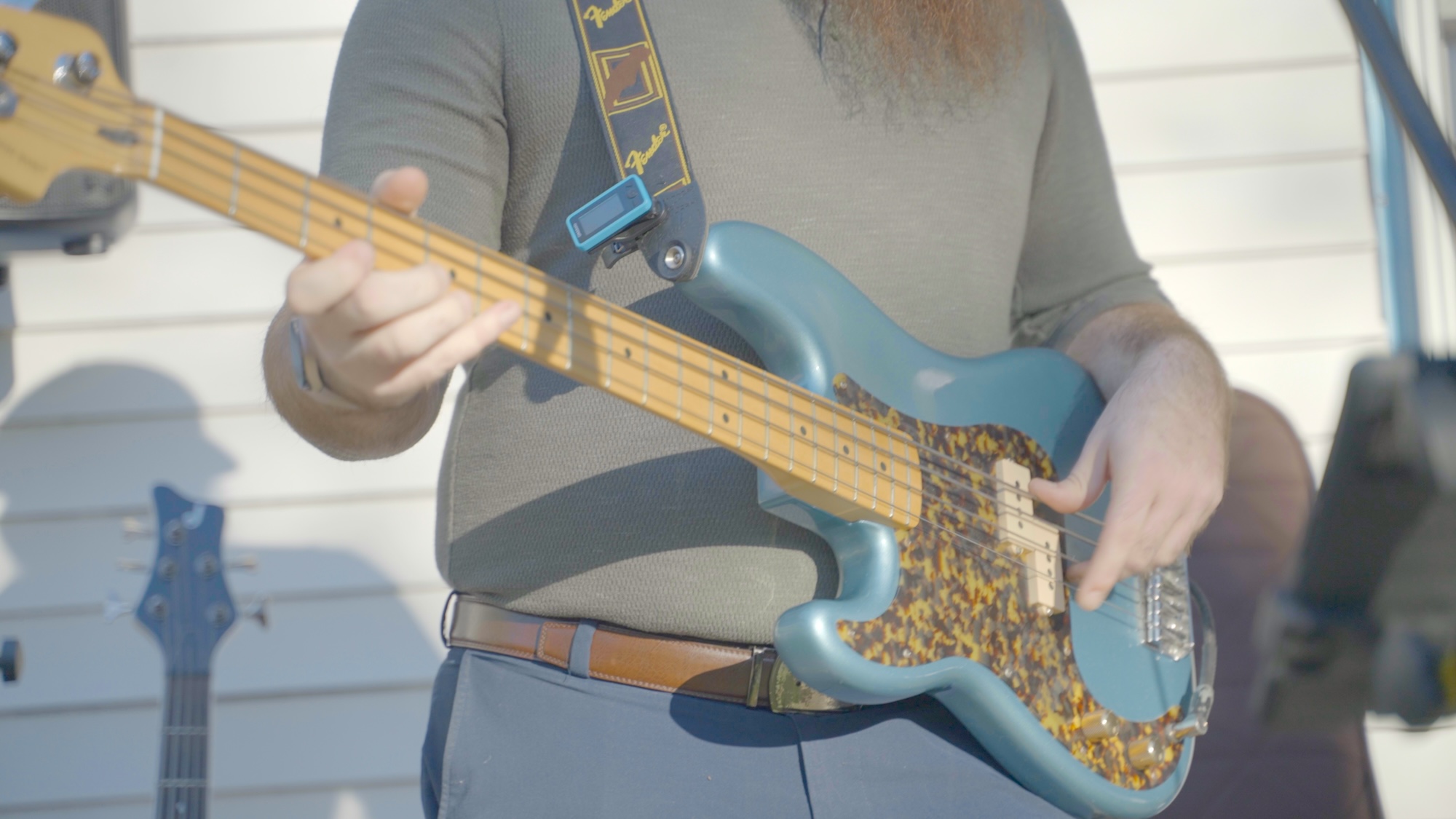 Person playing bass at the Castle Studios 1 year anniversary party.